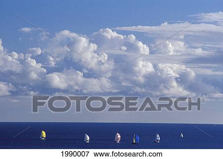 Stock Photo - Clouds In Sky Overlooking Ocean With Sailboats In Distance.. Fotosearch