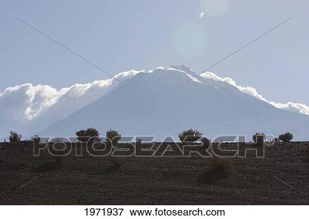 Stock Photo - Clouds Over Aucanquilcha Volcano, Antofagasta Region, Chile. Fotosearch