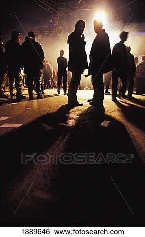 Clubbers Stood At End Of Night In Silhouette On Street View Large Photo Image Stock Photograph - Clubbers Stood At End Of Night In Silhouette On Street. Fotosearch