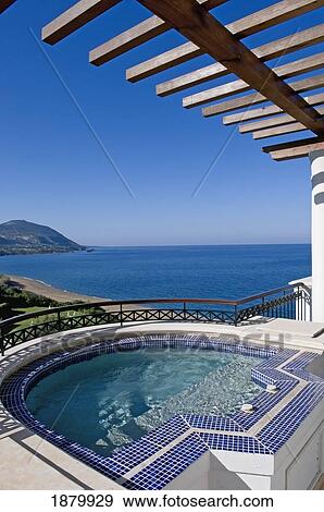 Stock Photo - Coastal view and pergola over swimming pool, Part of the Adonis & Aphrodite-Suite, Anassa-Hotel, Thonos Hotels, Cyprus. Fotosearch