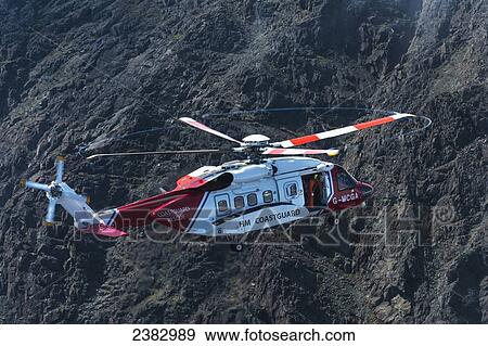 Coastguard rescue helicopter hovering above ridge in the Black Cuillin; Isle of Skye, Scotland View Large Photo Image Stock Photo - Coastguard rescue helicopter hovering above ridge in the Black Cuillin; Isle of Skye, Scotland. Fotosearch