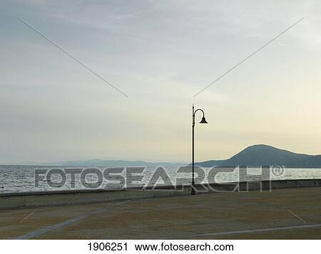 Stock Image - Coastline At Dusk, Street Lamp, Elba, Tuscany, Italy. Fotosearch