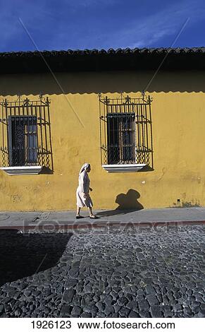 Stock Image - Cobblestoned Streets And Beautifully Painted Walls. Fotosearch
