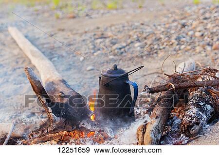 Stock Photo - Coffee pot in the campfire; Dawson, Yukon, Canada. Fotosearch