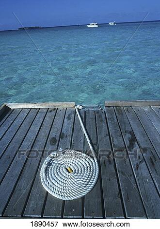 Stock Photo - Coiled Rope On Jetty. Fotosearch
