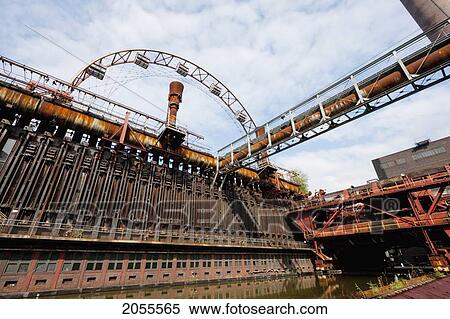 Stock Photography - Coke Furnaces And Sun Wheel At The Zollverein Coking Plant, Essen, North Rhine-Westphalia, Germany. Fotosearch