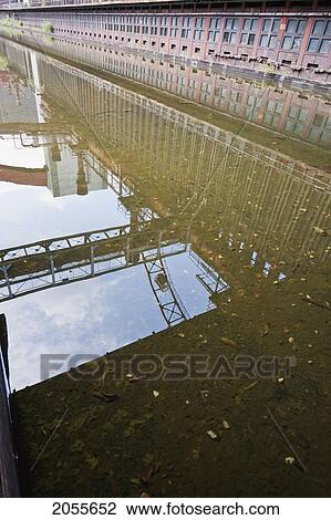 Stock Image - Coke Ovens Reflected In The Pool Of The Zollverein Coking Plant, Essen, North Rhine-Westphalia, Germany. Fotosearch