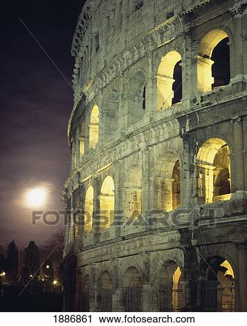 Stock Image - Coliseum At Night With Full Moon. Fotosearch