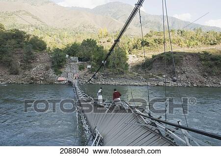Stock Image - Collapsed Suspension Bridge Over The Jelhum River After The 8 October 2005 Earthquake, Garhi Dopatta, Azad Jammu & Kashmir, Pakistan. Fotosearch