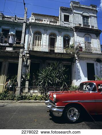 Stock Image - Colonial Style House Aand Old Car Vedado, Havana, Cuba. Fotosearch