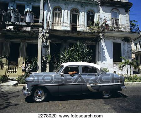 Colonial style house and old car in Vedado; Havana, Cuba View Large Photo Image Stock Image - Colonial style house and old car in Vedado; Havana, Cuba. Fotosearch
