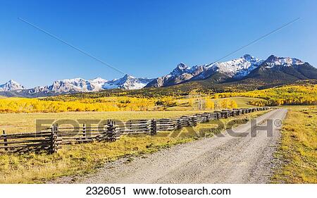 Colorado, Dallas Divide, Beautiful Autumn Landscape, Dirt Road Leading Torward Aspen Mountains. View Large Photo Image Stock Image - Colorado, Dallas Divide, Beautiful Autumn Landscape, Dirt Road Leading Torward Aspen Mountains.. Fotosearch