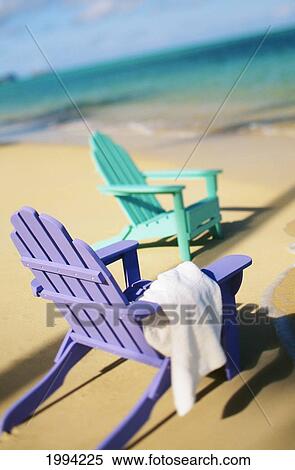 Stock Photography - Colorful Beach Chairs On Beach, Calm Waves Washing Ashore Turquoise Water, Selective Focus. Fotosearch