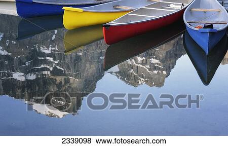 Stock Photo - Colorful Canoes At Moraine Lake; Banff, Alberta, Canada. Fotosearch