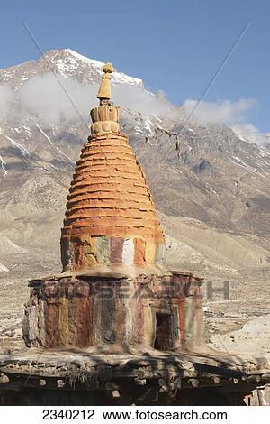 Stock Image - Colorful Chorten (Stupa) With Annapurna Peak; Geling, Upper Mustang Valley, Nepal. Fotosearch