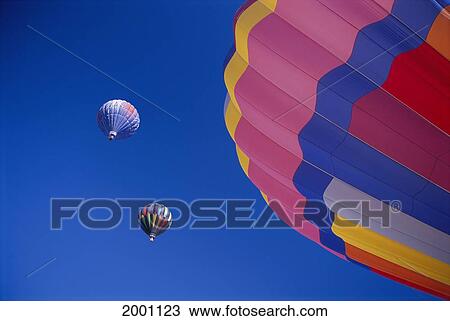 Stock Image - Colorful Hot Air Balloons Against Cloudless Blue Sky. Fotosearch