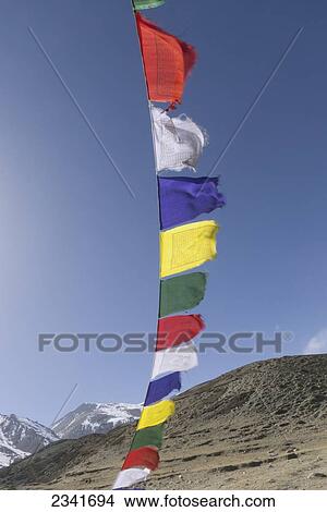 Colorful Prayer Flags Against Blue Sky With Peaks In Distance; Upper Mustang Valley, Nepal View Large Photo Image Picture - Colorful Prayer Flags Against Blue Sky With Peaks In Distance; Upper Mustang Valley, Nepal. Fotosearch