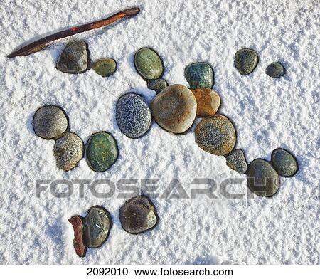 Stock Image - Colorful Rocks In Snow On Beach At Florencia Bay In Pacific Rim National Park; Vancouver Island British Columbia Canada. Fotosearch