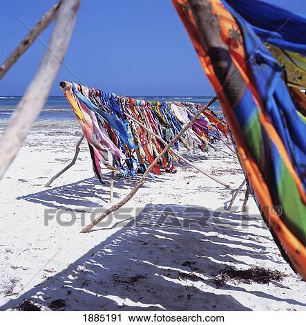 Stock Image - Colorful Sarongs Blowing In Wind On The Beach. Fotosearch