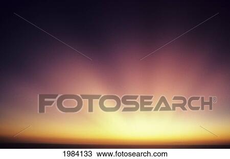 Stock Image - Colorful Sunset, Beautiful Light Rays Bursting From Horizon.. Fotosearch