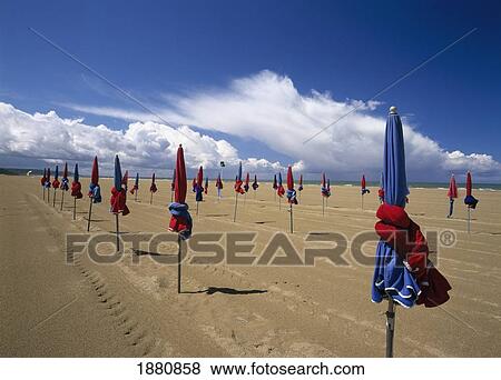 Stock Photo - Colorful Umbrellas On Beach. Fotosearch