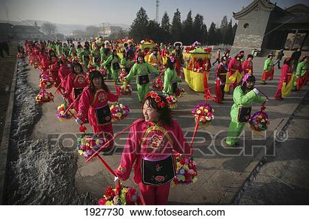 Stock Image - Colorfully Dressed Local Women In A Rural Chinese New Year Procession, At The Valley Of The Shi Li River Located At The Base Of The Wuzhou Shan Mountains, Near Datong, Shanxi, China. Fotosearch