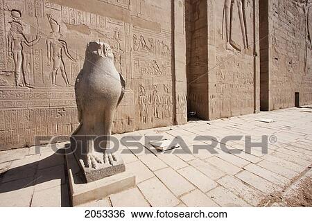 Stock Photograph - Colossal Black Granite Statue Of Horus As A Falcon In Front Of The Entrance Pylon Of The Temple Of Horus At Edfu, Aswan, Egypt. Fotosearch