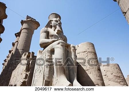Stock Photo - Colossal Statue Of Statue Of Ramses Ii And Queen Nefertari In The Courtyard Of Ramses Ii The Luxor Temple, Qina, Egypt. Fotosearch