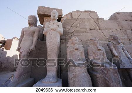 Stock Photograph - Colossal Statues In The Courtyard Of The Cachette In The Great Temple Of Amun In The Karnak Temple Complex, Luxor, Qina, Egypt. Fotosearch