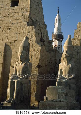 Stock Photo - Colossi Of Ramses 2Nd With Minaret. Fotosearch