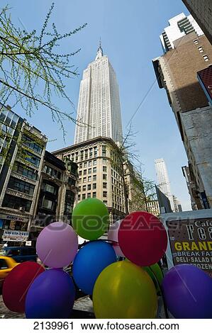 Stock Image - Coloured Balloons In Front Of The Empire State Building, Manhattan, New York, Usa. Fotosearch