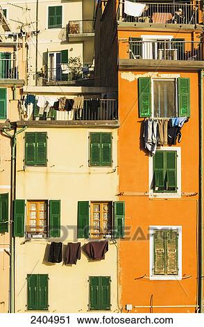 Stock Image - Coloured houses in the village of Riomaggiore, Cinque Terre; Liguria, Italy. Fotosearch