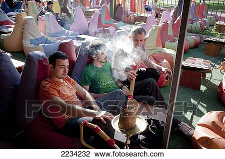 Colourful bean bags adorn the Tophane Narghile Cafes attracting a younger crowd to hang out, smoke Narghile smoking pipe, drink tea and play backgammon, close to the Istanbul Modern, Istanbul, Turkey. Photo View Large Photo Image Stock Image - Colourful bean bags adorn the Tophane Narghile Cafes attracting a younger crowd to hang out, smoke Narghile smoking pipe, drink tea and play backgammon, close to the Istanbul Modern, Istanbul, Turkey. Photo. Fotosearch