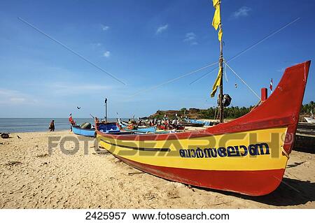 Stock Photo - Colourful boat and fishermen on Bekal beach; Northern Kerala, India. Fotosearch