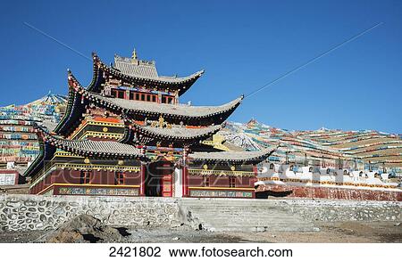 Stock Image - Colourful Buddhist temple and many prayer flags and stupas at a Tibetan monastery near Hot Spring city; Madoi County, Tibet. Fotosearch