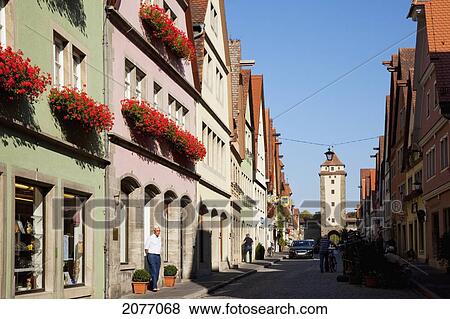 Stock Photo - Colourful Buildings Along A Street With Red Flowers Blossoming In Window Planter Boxes; Rothenburg Ob Der Tauber Bavaria Germany. Fotosearch