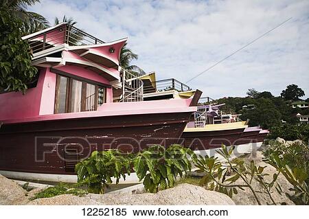 Stock Photography - Colourful bungalows line the beaches of Ko Phanang's beaches; Ko Phangan, Thailand. Fotosearch