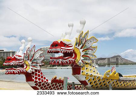 Stock Image - Colourful chinese dragonboats along the waterfront; Honolulu, Oahu, Hawaii, United States of America. Fotosearch