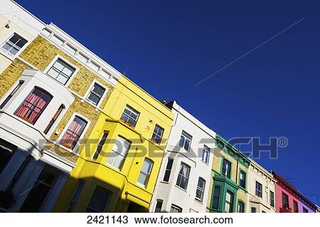 Stock Image - Colourful facades of residential buildings in a row, Notting Hill; London, England. Fotosearch