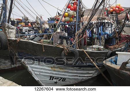 Picture - Colourful fishing boats portraying fishermen's lives; Sidi Ifni, Morocco. Fotosearch