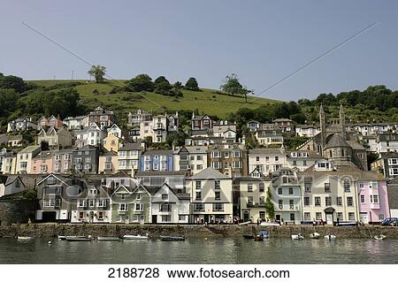 Stock Photo - Colourful houses and boats along the riverbank; Dartmouth, South Hams, Devon, England. Fotosearch