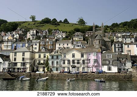 Colourful houses and boats along the riverbank; Dartmouth, South Hams, Devon, England View Large Photo Image Stock Photo - Colourful houses and boats along the riverbank; Dartmouth, South Hams, Devon, England. Fotosearch