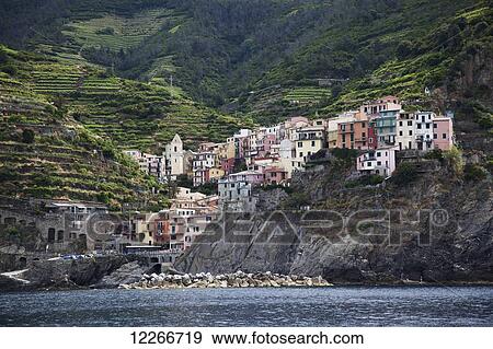 Colourful houses on the rugged coast; Riomaggiore, Liguria, Italy View Large Photo Image Stock Photo - Colourful houses on the rugged coast; Riomaggiore, Liguria, Italy. Fotosearch