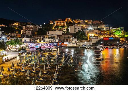 Colourful lights illuminate and reflect on the water in the harbour; Bali, Crete, Greece View Large Photo Image Stock Photo - Colourful lights illuminate and reflect on the water in the harbour; Bali, Crete, Greece. Fotosearch