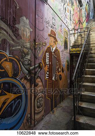 Stock Photo - Colourful murals painted on a wall beside steps; Valparaiso, Chile. Fotosearch