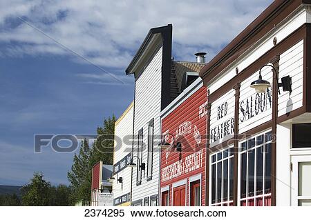 Stock Photography - Colourful old wooden store front with clouds and blue sky; Dawson City, Yukon, Canada. Fotosearch