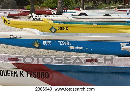 Stock Photo - Colourful outrigger canoes on the beach; Island of Hawaii, Hawaii, United States of America. Fotosearch