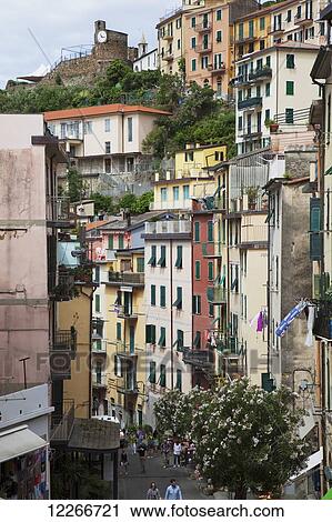 Colourful residential buildings and pedestrians; Riomaggiore, Liguria, Italy View Large Photo Image Stock Image - Colourful residential buildings and pedestrians; Riomaggiore, Liguria, Italy. Fotosearch
