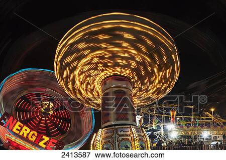 Stock Photo - Colourful rides at an amusement park at nighttime; South Shields, Tyne and Wear, England. Fotosearch