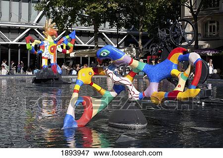 Stock Photo - Colourful Sculptures In A Pool; Paris, France. Fotosearch